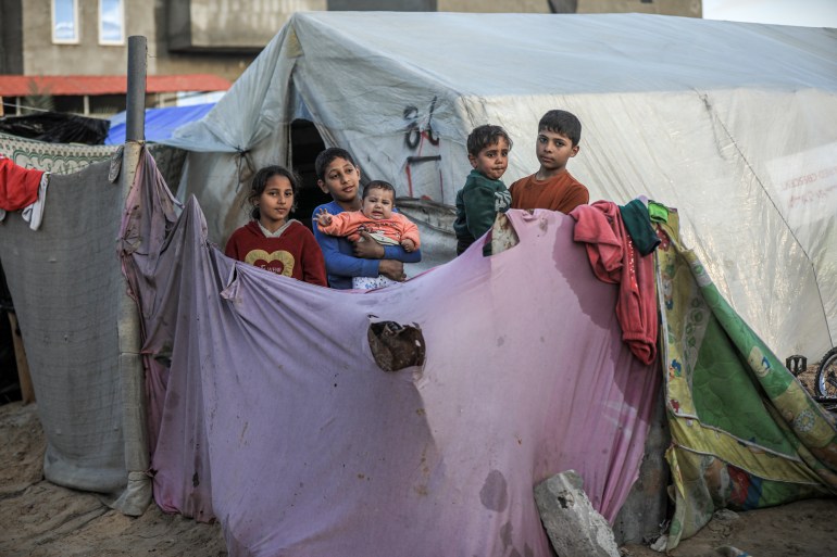 Pięcioro dzieci stojących przed namiotem