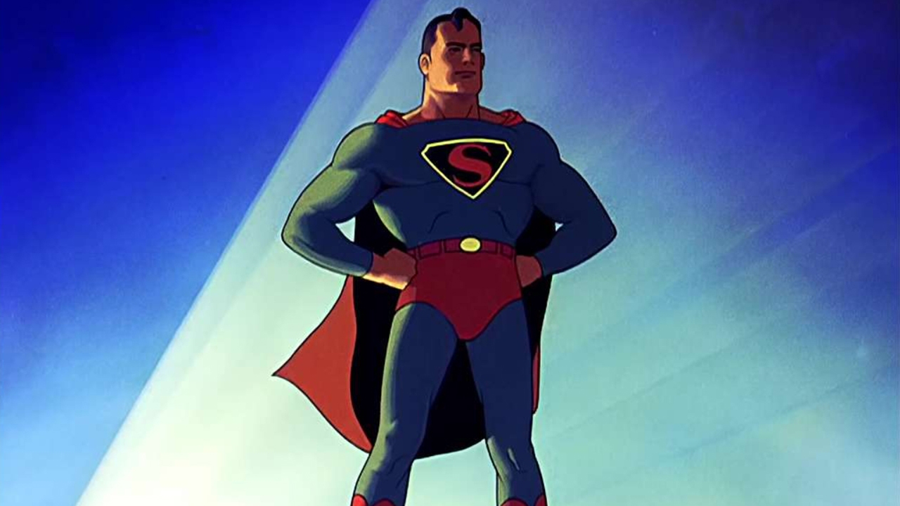 Komiks Supermana.  Mężczyzna ubrany w niebieskie body z ogromną literą S na piersi.  Ma również na sobie czerwone spodnie i czerwoną pelerynę.  Trzymał ręce na biodrach w mocnej, pewnej pozie.