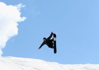 Snowboardzista skacze w powietrzu w ośrodku Falls Creek Resort w Australii