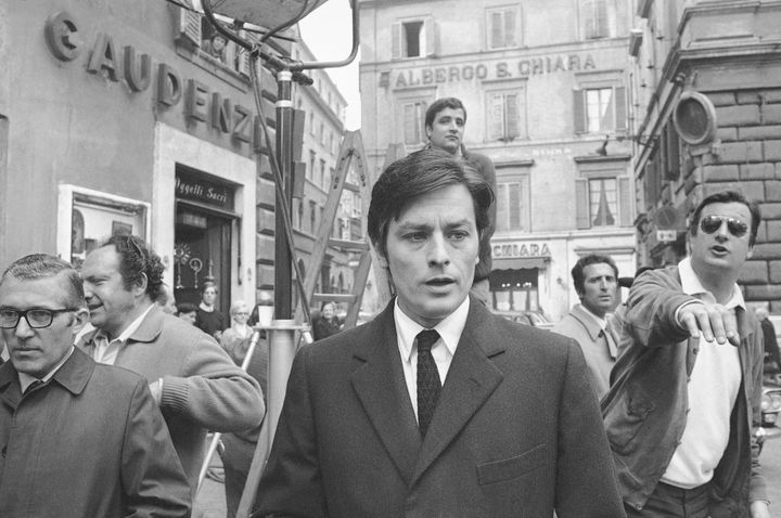 PLIK - Francuski aktor Alain Delon odchodzi od planu zdjęciowego nowego filmu, "Sycylijczycy," podczas przerwy w strzelaninie w centrum Rzymu, 27 marca 1969 r. (AP Photo/Jim Pringle, File)